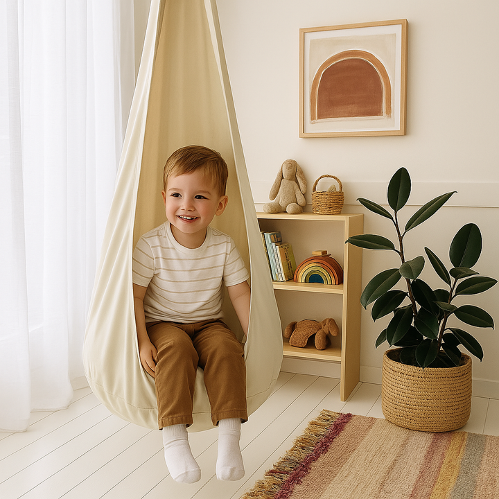 a-child-sitting-in-a-beige-pod-swing