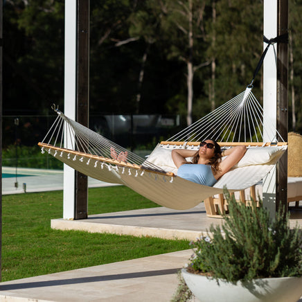 king-size-cream-coloured-quilted-spreader-bar-hammock-lady-laying-down