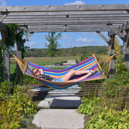 cotton-spreader-bar-hammock-in-tropical-outdoors