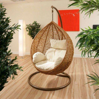 hanging-outdoor-rattan-egg-swing-chair-with-cream-cushion-pod