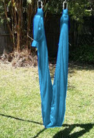 Medium Teal Nylon Wrap Swing (450x180cm) hanged in a tripod stand